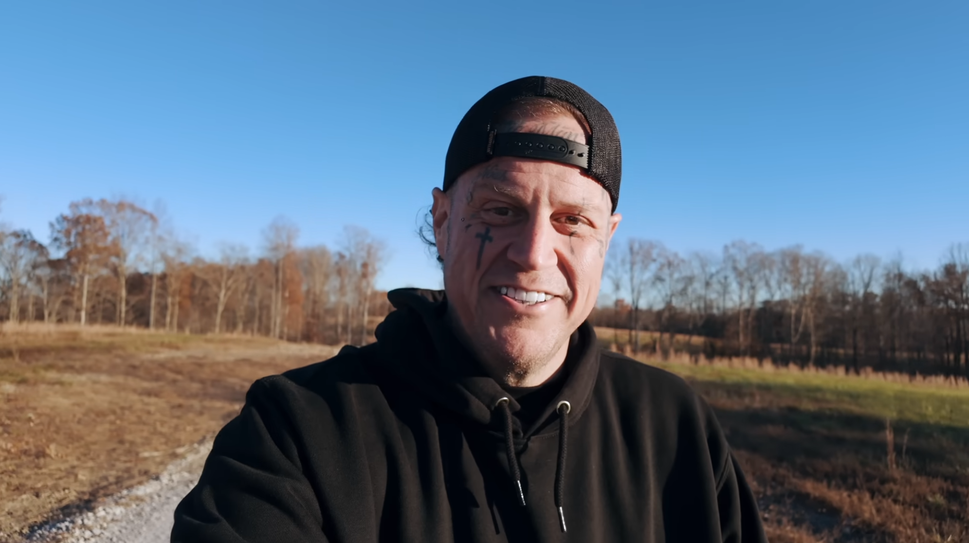 Jelly Roll after shaving his beard for the first time in about a decade, wearing a black cap and hoodie.