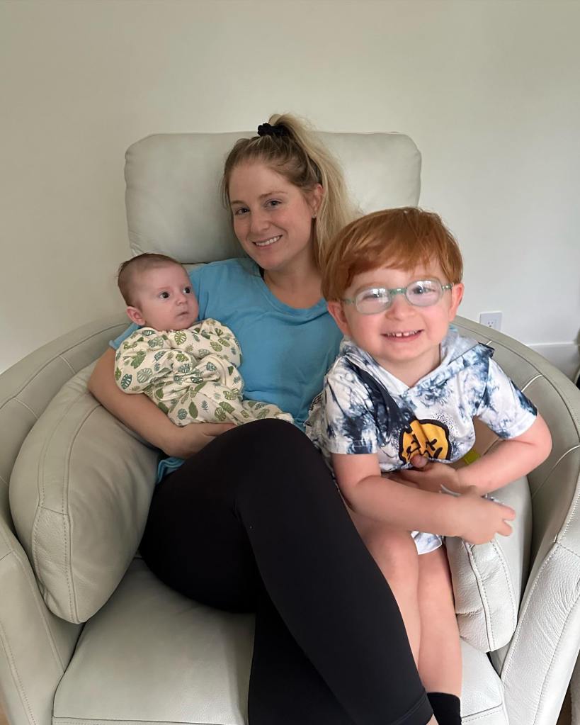 Meghan Trainor smiling with her infant and toddler alongside husband Daryl Sabara.