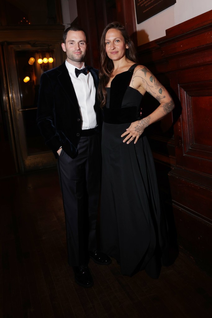 Penn Badgley and Domino Kirke at the Giorgio Armani Spring 2025 fashion show.