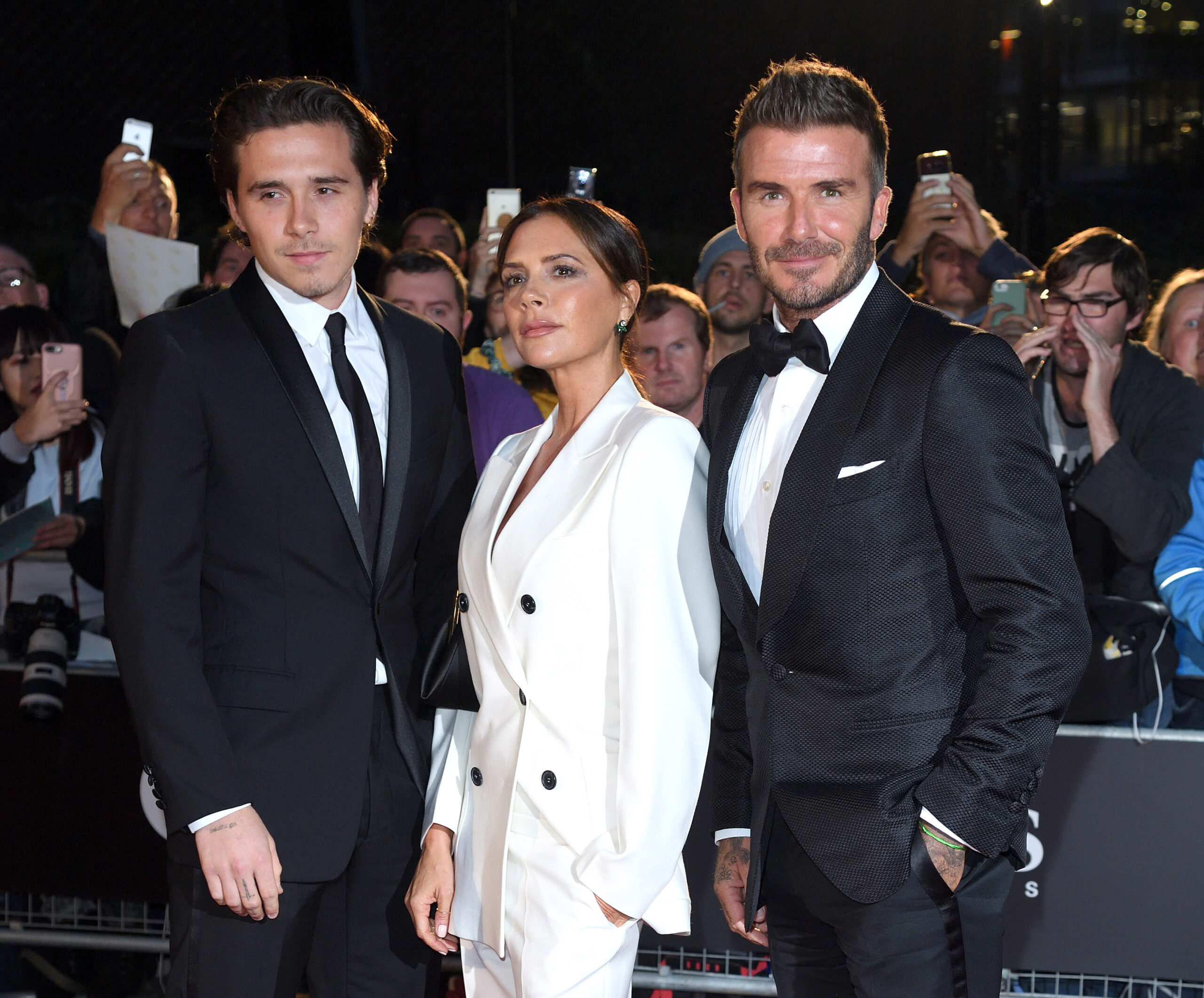 Brooklyn Beckham with parents Victoria and David Beckham at the GQ Men of the Year Awards 2019.