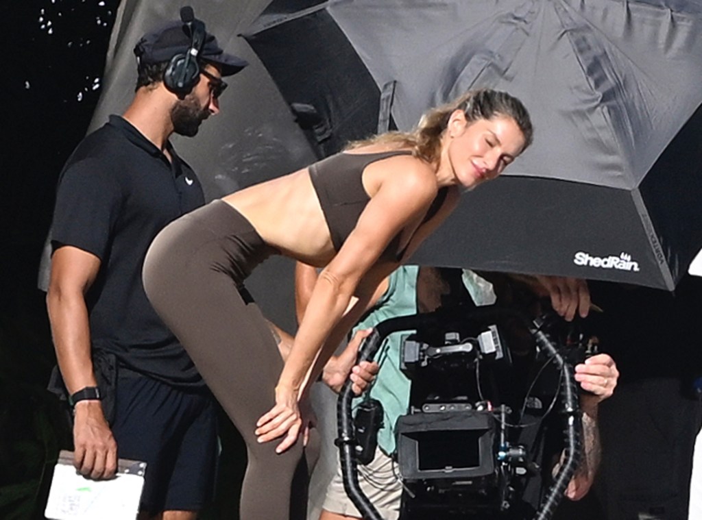 Gisele Bundchen in brown activewear filming a fitness commercial on Miami Beach.
