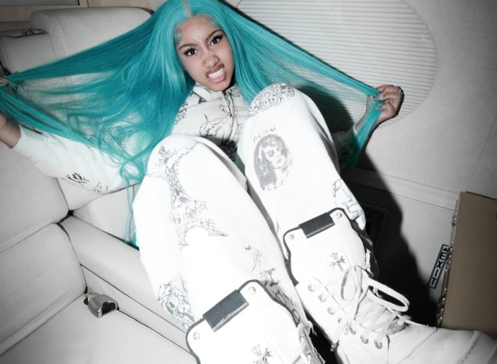 North West with electric blue hair and diamond-encrusted shark grillz.