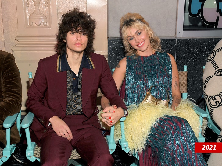 Miley Cyrus on the red carpet at the Avatar: Fire and Ash premiere, showing a diamond ring on her left hand.