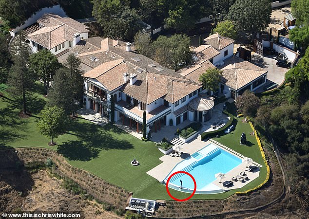 Before the rebuild: the original Mediterranean-style mansion with the Rocky statue by the pool.