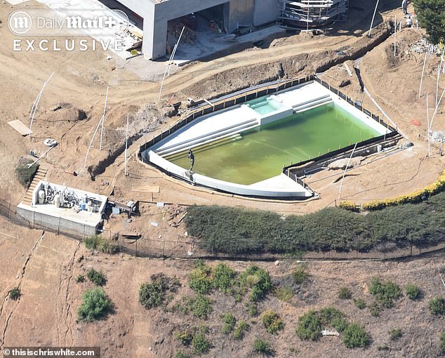 Rocky statue remains in the pool, which has turned construction green during the rebuild.