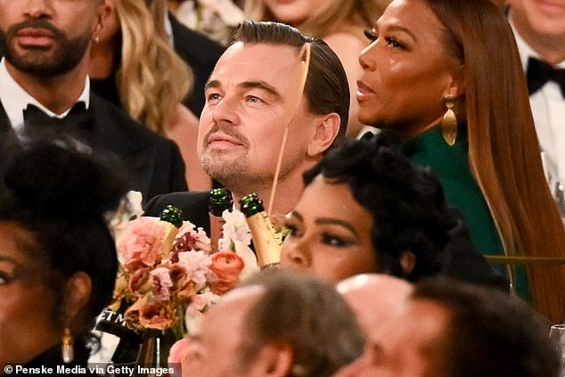 Leonardo DiCaprio reacts after being an early target of Nikki Glaser's age-gap joke