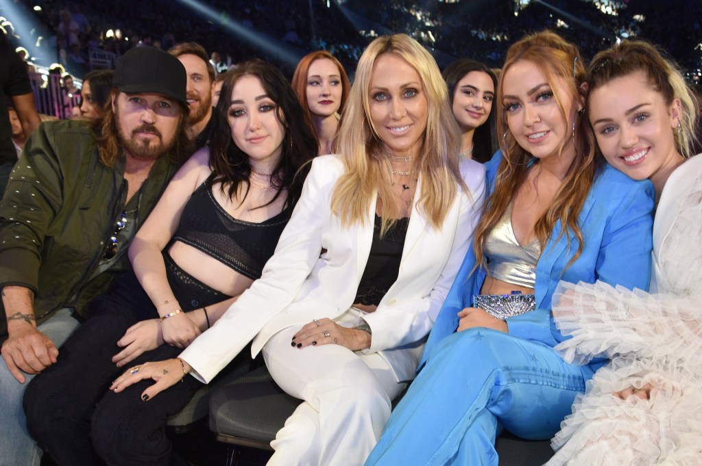 Recording artists Billy Ray Cyrus, Noah Cyrus, Tish Cyrus, Brandi Cyrus, and Miley Cyrus seated together.