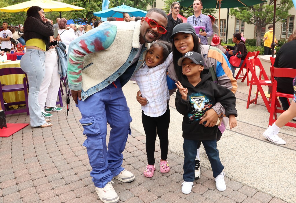 Ray J with Princess Love and their children at a movie screening.