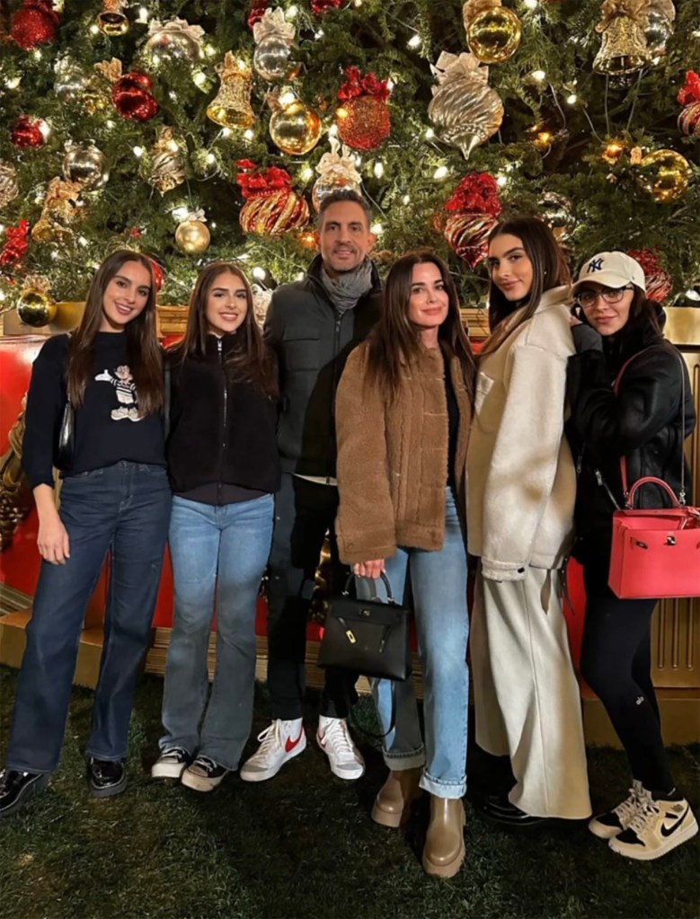 Kyle Richards and Mauricio Umansky with their four daughters in front of a Christmas tree.