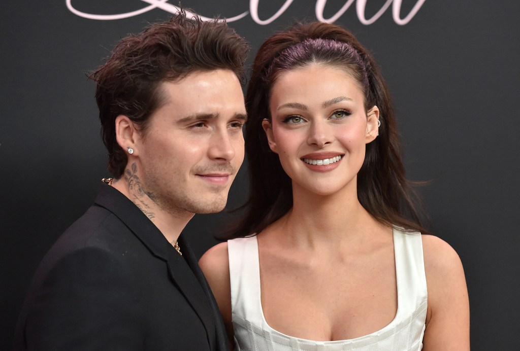 Brooklyn Beckham and Nicola Peltz Beckham pose together at an event.