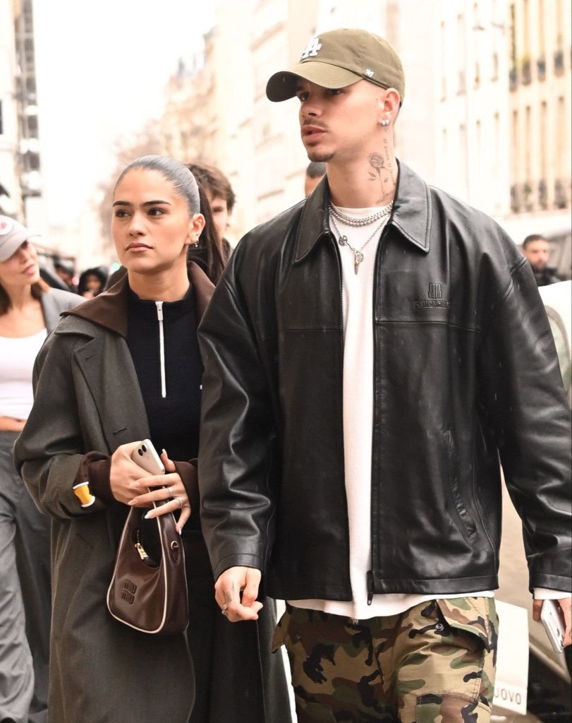 Romeo Beckham and Kim Turnbull walk together between vintage shops in Paris.