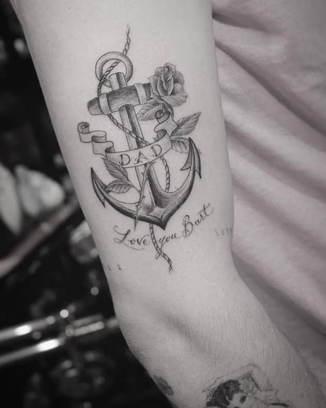 Close-up of Brooklyn Beckham's anchor tattoo showing 'dad' and 'Love you Bust' before the reported cover-up
