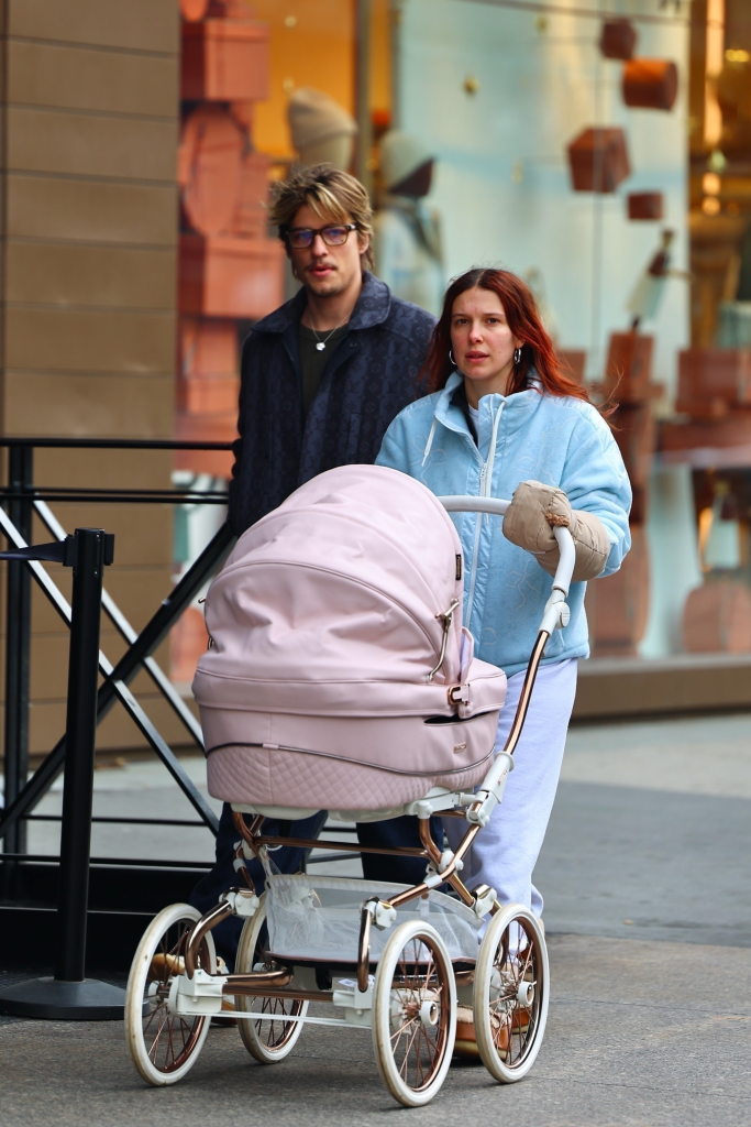 Millie Bobby Brown and Jake Bongiovi walk in New York City pushing a pink stroller.