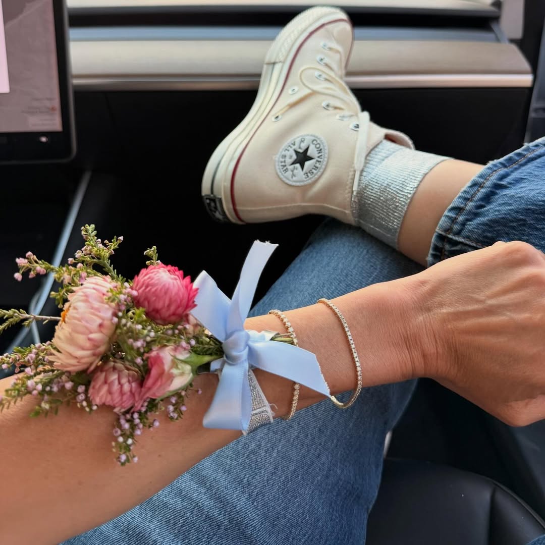 Close-up of a corsage and bracelet with a Converse sneaker in the background at Lauren Conrad's prom-themed party.