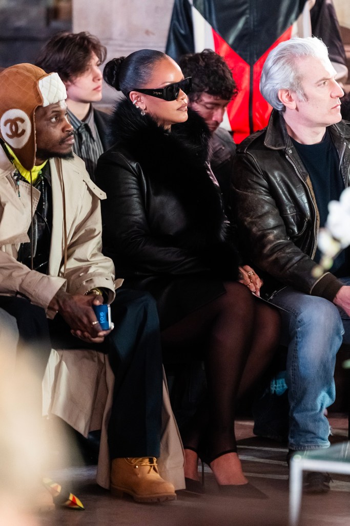 Rihanna sits inside the AWGE fashion show next to A$AP Nast.
