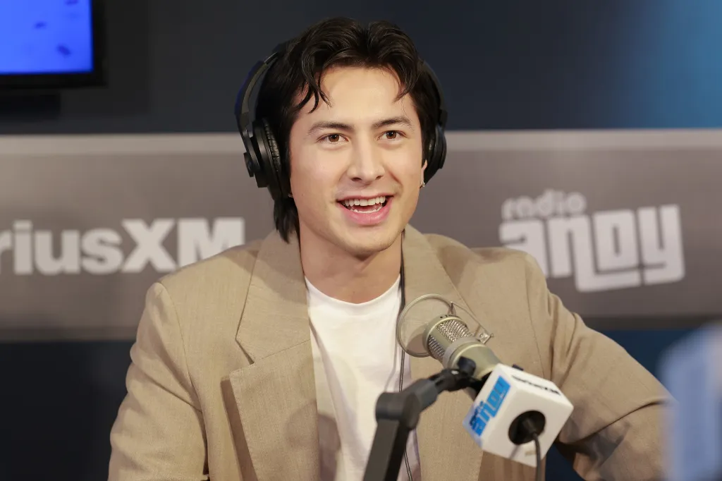 Hudson Williams speaking into a microphone at SiriusXM Studios during a January interview.