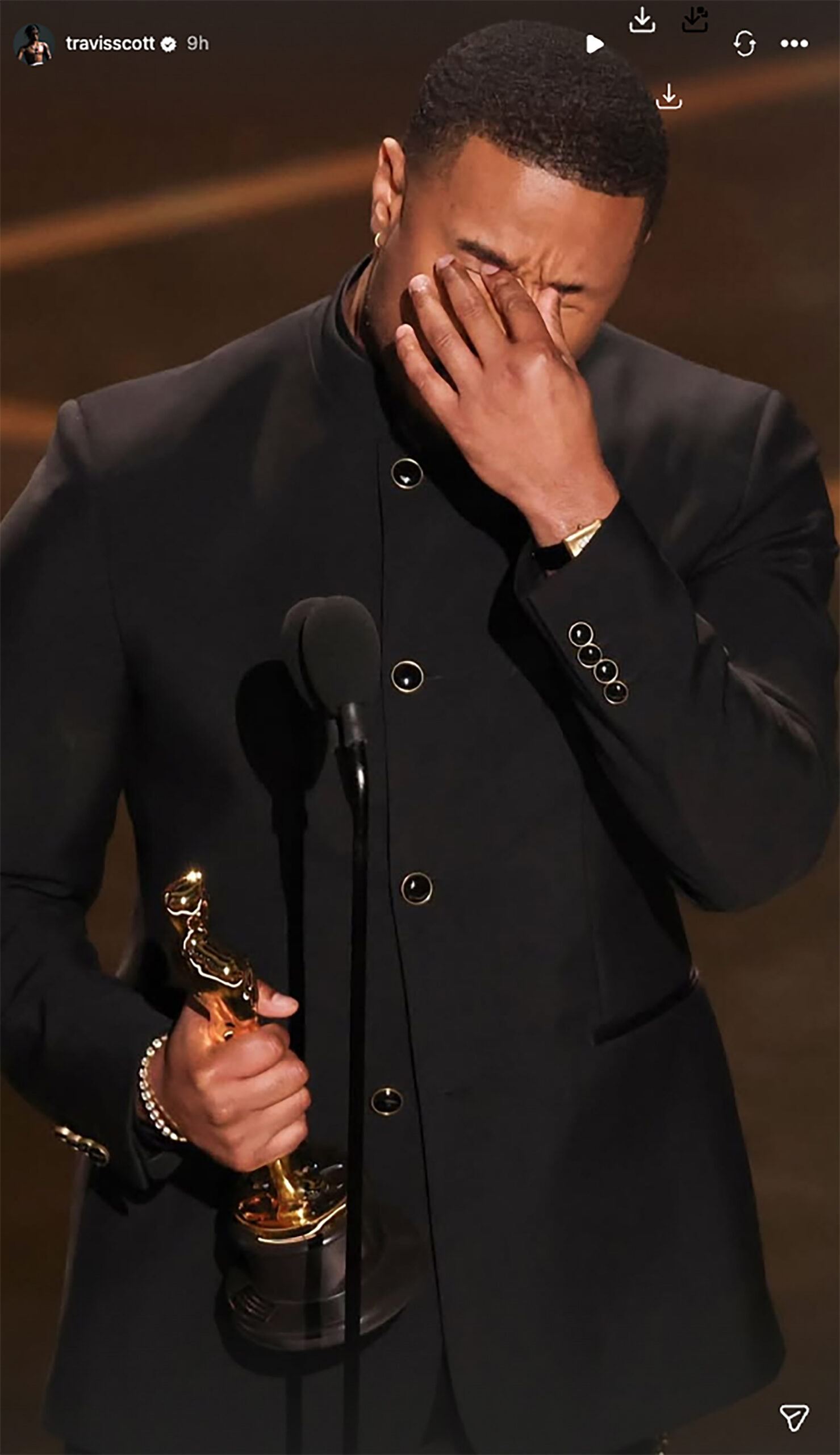 Michael B. Jordan appears emotional holding his Oscar onstage in a screenshot from Travis Scott's Instagram Story.