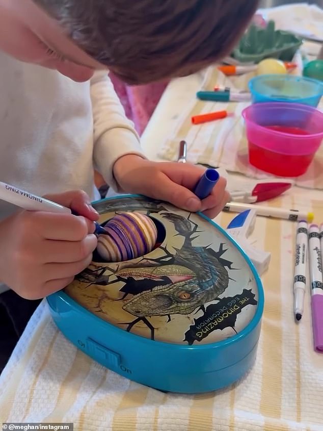 Archie decorating an Easter egg at home