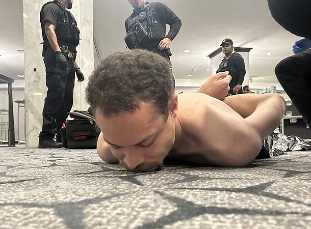 A shirtless suspect, identified by law enforcement as 31-year-old Cole Tomas Allen, is restrained by officers at the Washington Hilton.