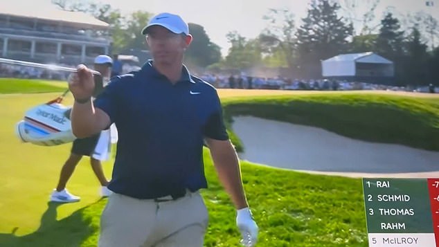 Rory McIlroy gestures toward marshals after a mid-swing interruption on Aronimink's 16th hole during the PGA Championship