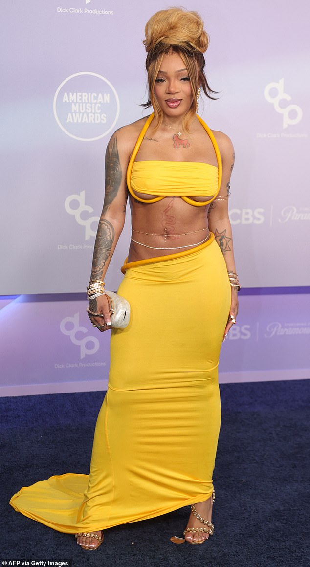 GloRilla in a minimal bandeau top and matching skirt on the 2026 American Music Awards red carpet.