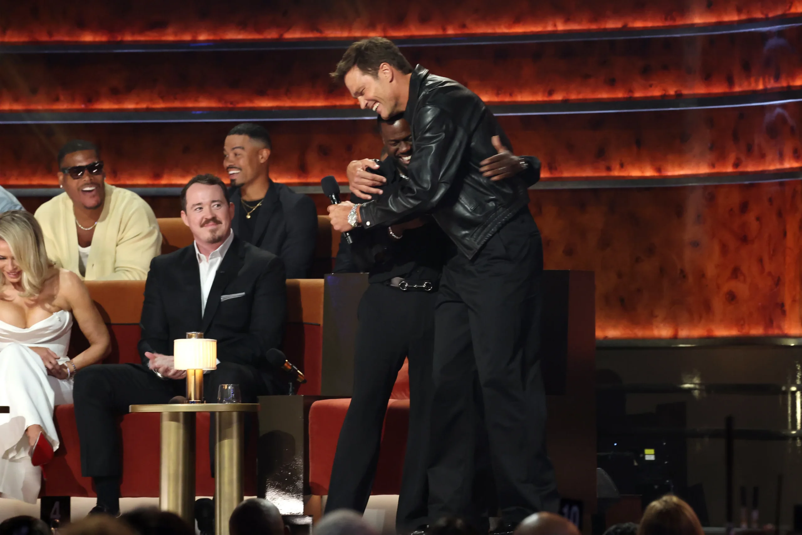 Tom Brady and Kevin Hart hug on stage during The Roast of Kevin Hart at the Netflix Is A Joke Festival.