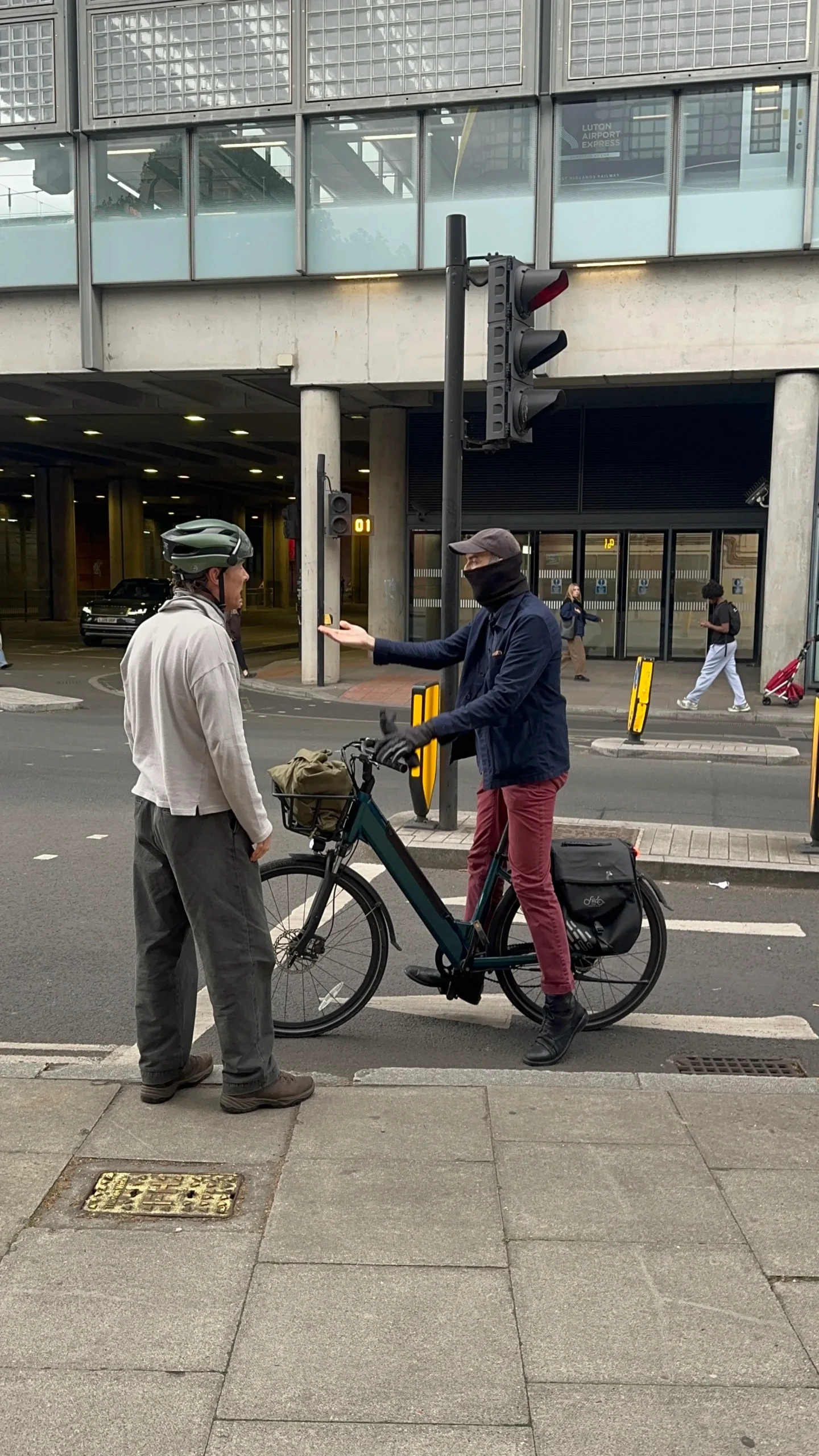 Cumberbatch and another cyclist stand with their bikes, blocking a lane during a heated exchange in London.
