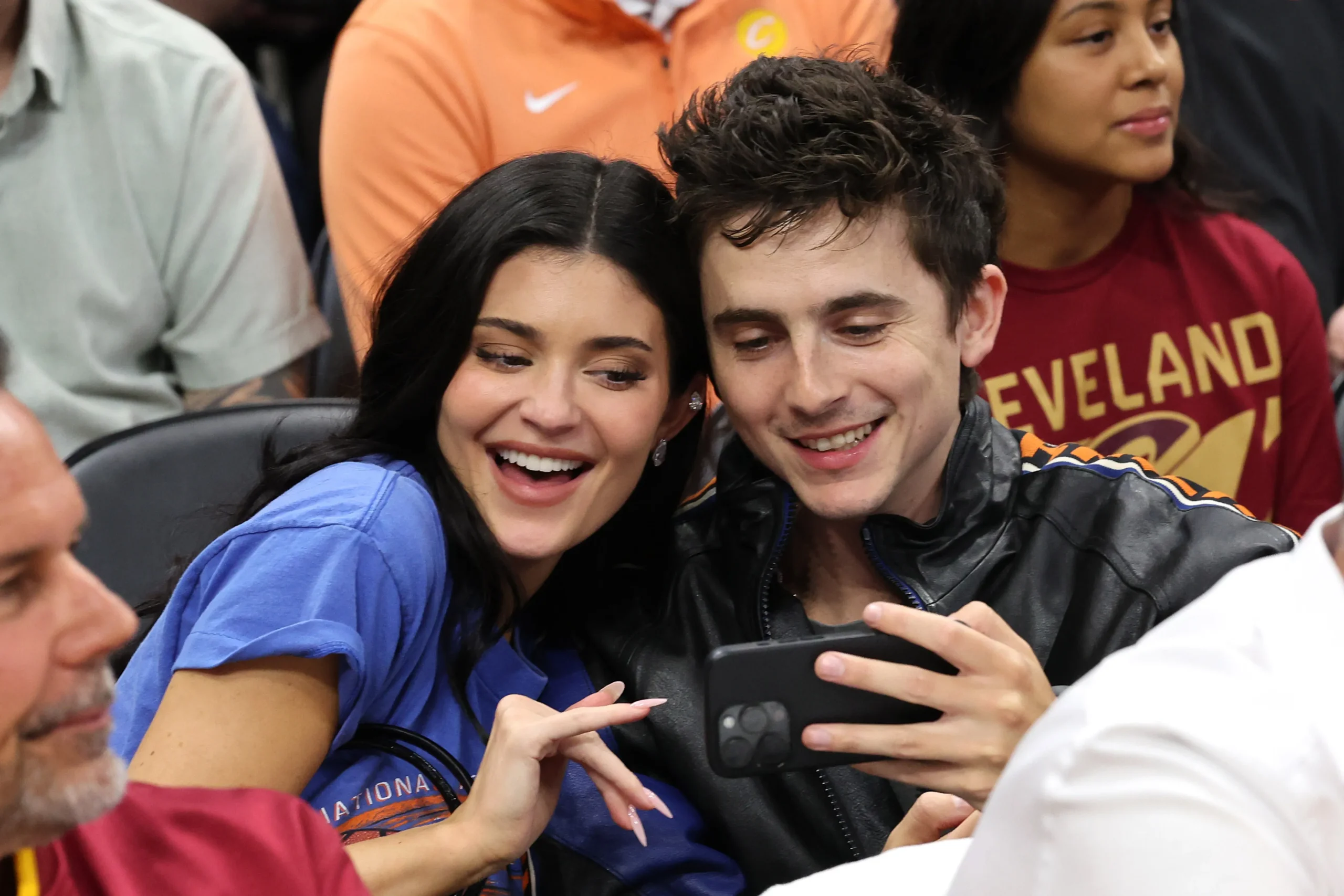 Kylie Jenner takes a selfie with Timothee Chalamet while they sit courtside in Knicks gear.