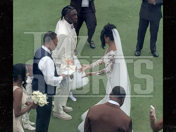 Bride and groom walking at an outdoor ceremony in Laguna Beach; image Sports. - TMZ