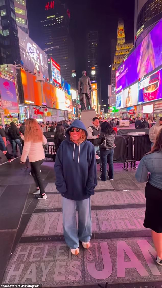 Sydney Sweeney takes in Times Square in a June 2026 clip credited to Scooter Braun's Instagram Story.