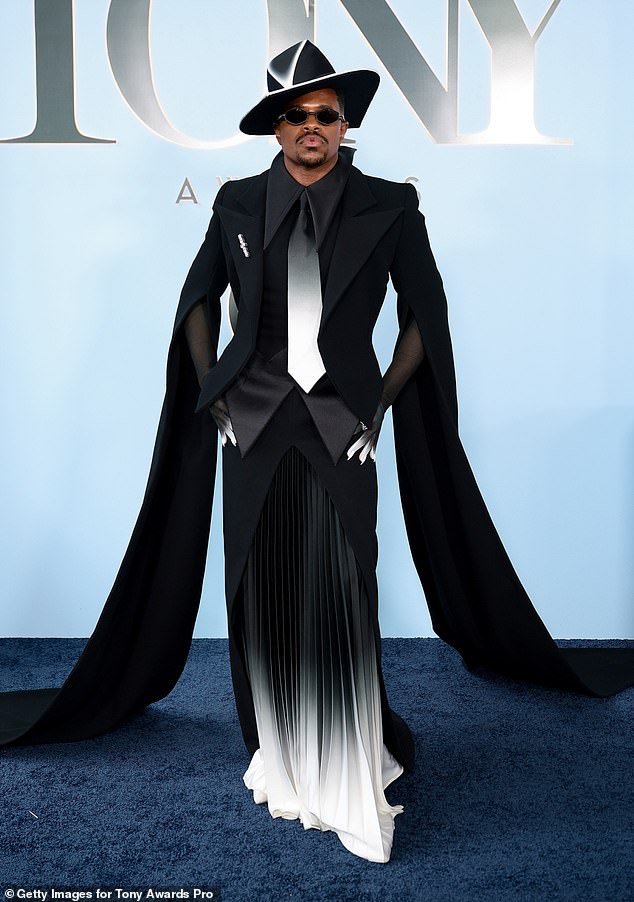 Jeremy Pope on the Tony Awards red carpet in a black top and a black-and-white skirt with dramatic streamers