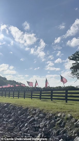 American flags lining a rural Tennessee fence as seen in Carrie Underwood's Instagram video