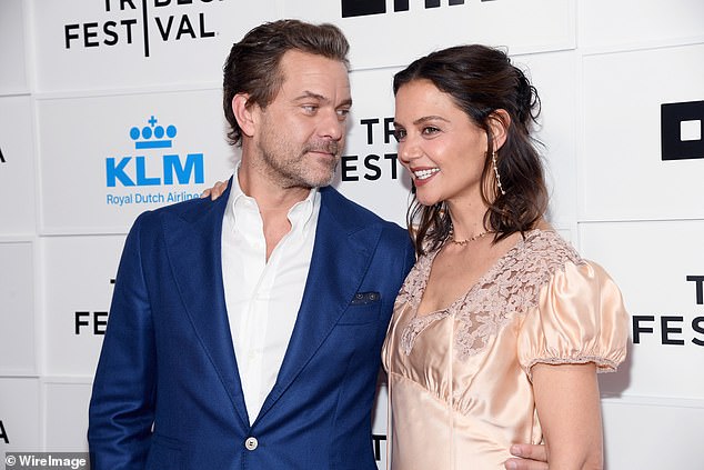 Joshua Jackson and Katie Holmes share a light moment during a Tribeca red carpet interview for Happy Hours.