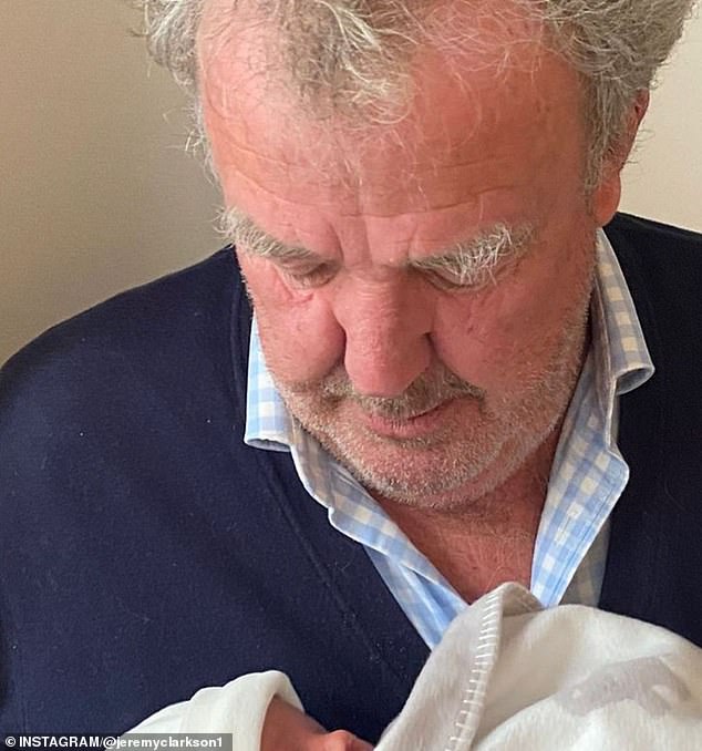 Jeremy Clarkson in a close-up portrait with a baby partially visible, reflecting his decision to slow down and prioritize health