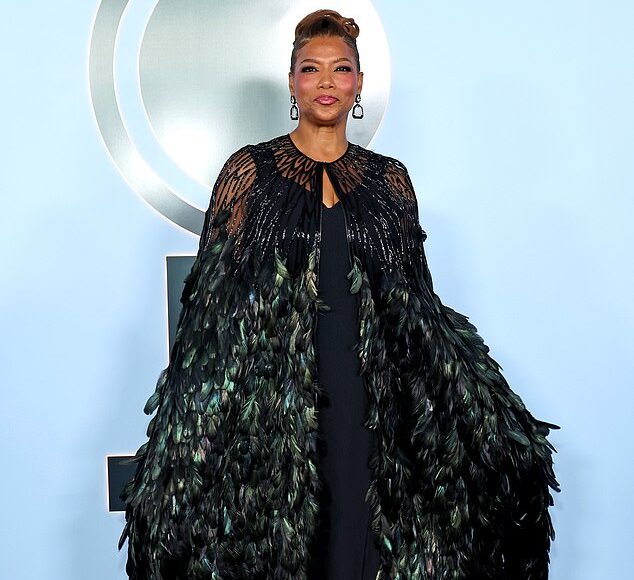 Queen Latifah in a dark-green feathered cape on the Tonys red carpet