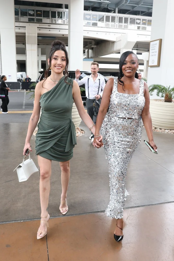 Jasmine Goode and Melissa Marie walk together on their wedding day at Crossed Keys Estate (Just Jared)