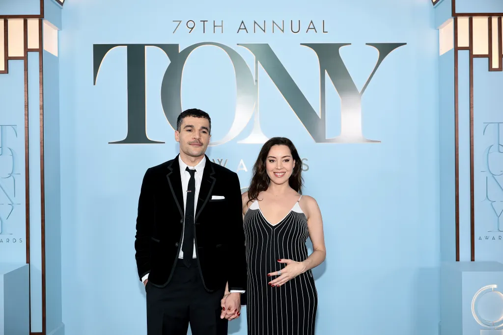 Aubrey Plaza and Christopher Abbott holding hands on the red carpet at the 79th Tony Awards.