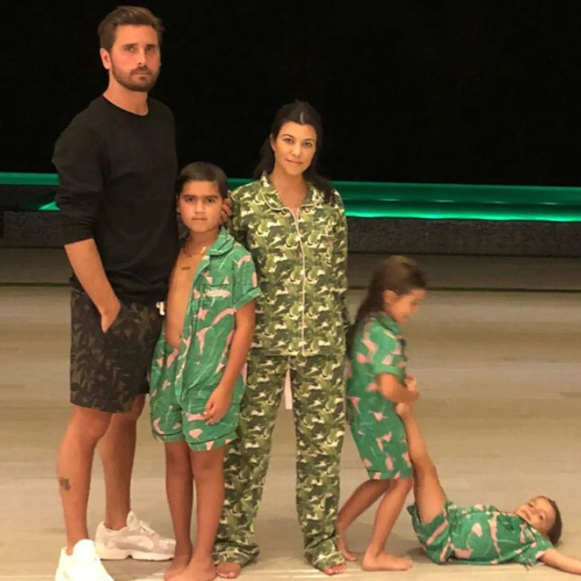 Kourtney Kardashian and Scott Disick with their three children-Mason, Penelope, and Reign-posing together.