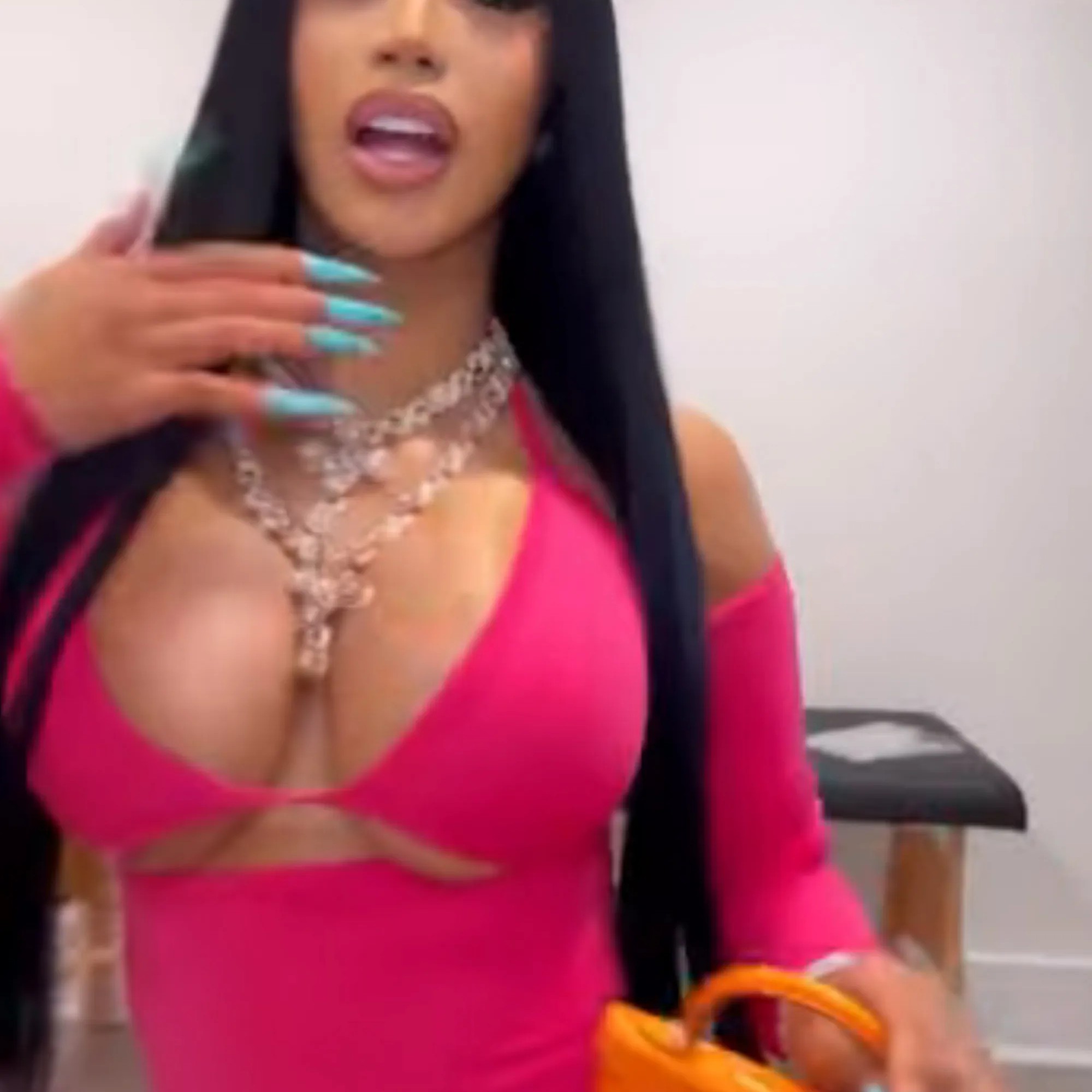 The "WAP" rapper (seen above) also carried a Knicks orange mini purse. - Instagram/@cardib
